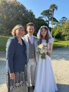 a smiling bride and groom with their celebrant Nicola