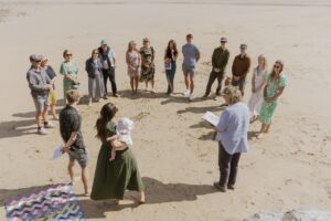Guests in a circle on the beach