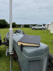 Register resting on the bonnet of a vintage tractor
